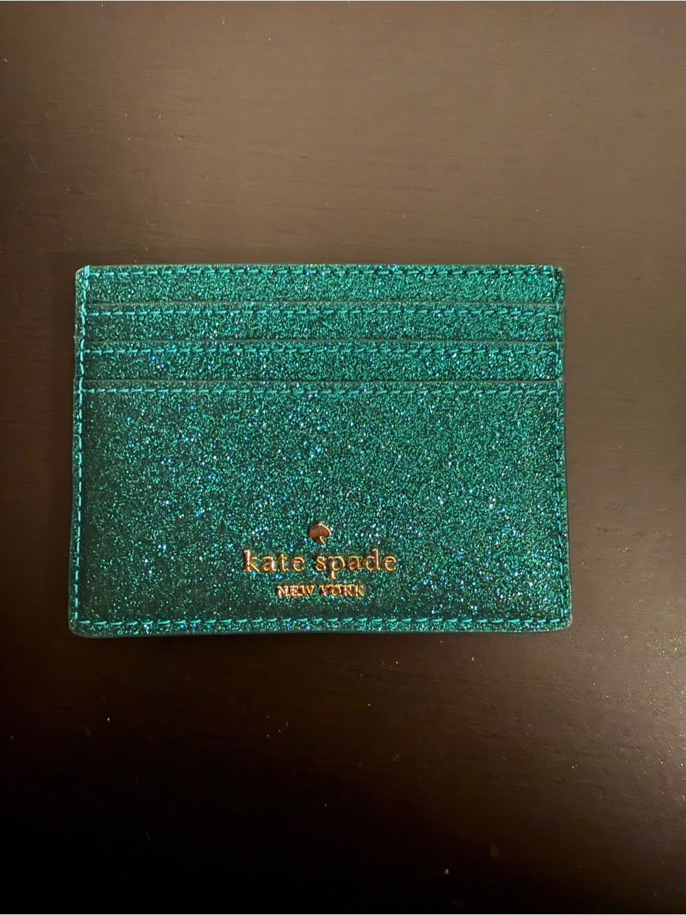 kate spade glitter cardholder in emerald sparkle with gold logo